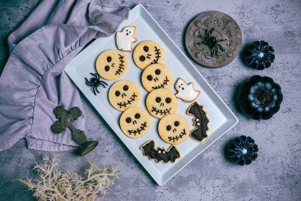 istock Freshly baked cookies with halloween decorations on concrete background 1717730239