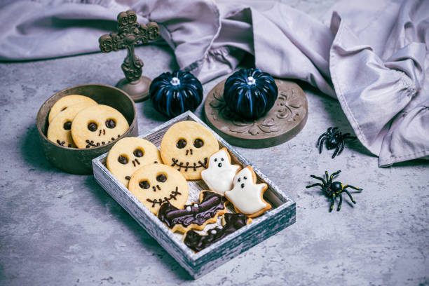 istock Freshly baked cookies with halloween decorations on concrete background 1717730256