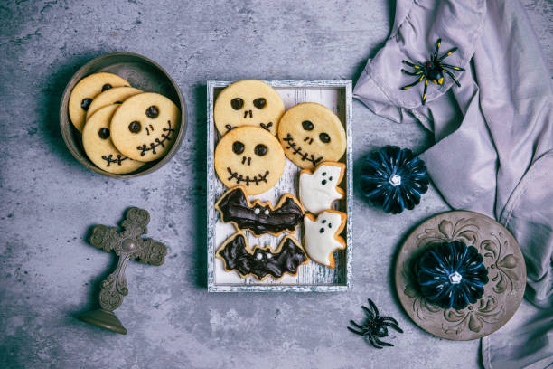 istock Freshly baked cookies with halloween decorations on concrete background 1717730640