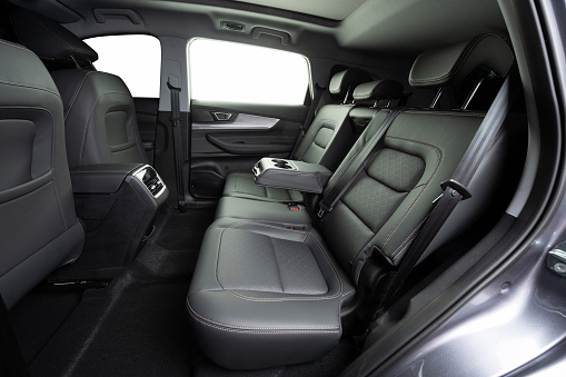 Car interior cleaning service theme. Clean SUV leather rear row seats