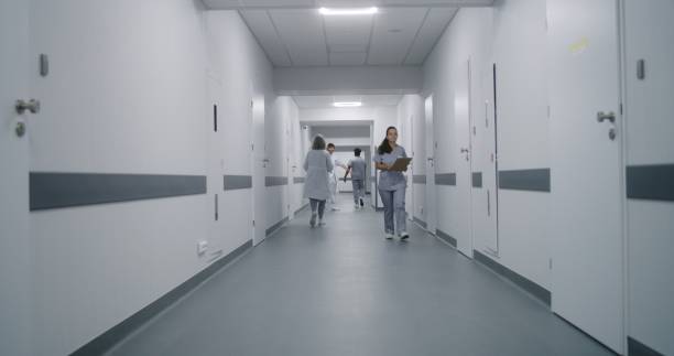 istock Multiracial medical staff walk clinic corridor 1717747017