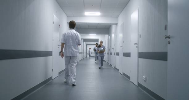 istock Multiracial medical staff walk clinic corridor 1717747905