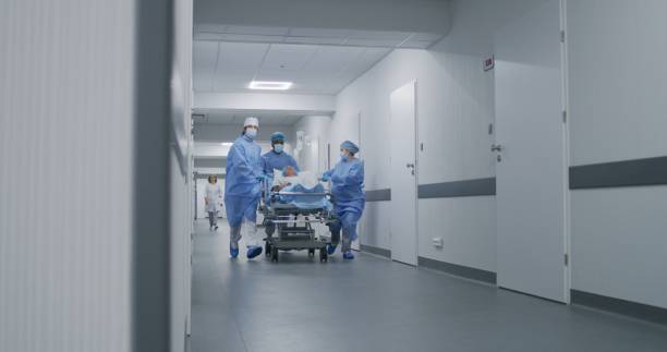 istock Doctors run and push gurney with injured patient 1717748435