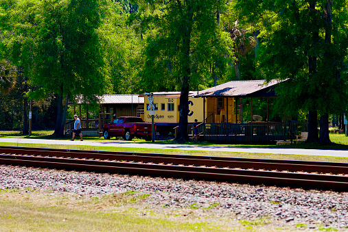 Folkston, Georgia, USA - April 5, 2021: An authentic Chessie System caboose converted to overnight lodging is popular with railfans as it sits alongside the double-track railroad at the “Folkston Funnel” in southeast Georgia near the Florida state line.