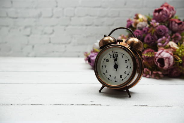 istock Alarm clock on wooden background 1717807792