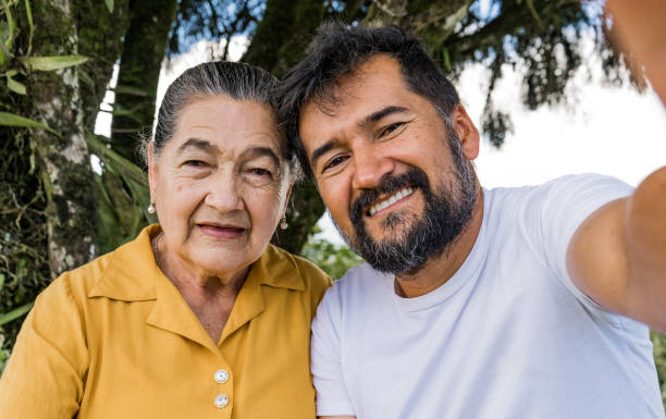 istock mother and son smiling while outdoors taking a selfie with their cell phone 1717808316
