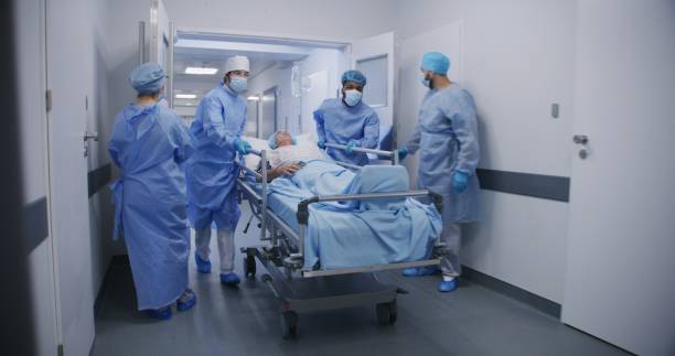 istock Multicultural doctors transport senior patient to operating room 1717824159
