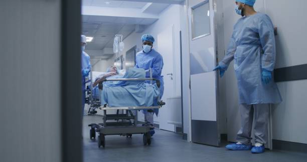 istock Nurse and paramedic open medical facility corridor 1717829015