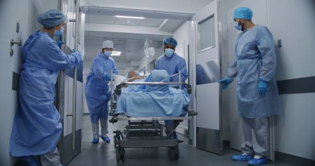 istock Nurse and paramedic open medical facility corridor 1717830431