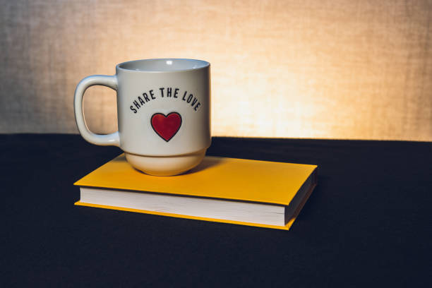 Mug with a book the theme of learning or creating a postcard