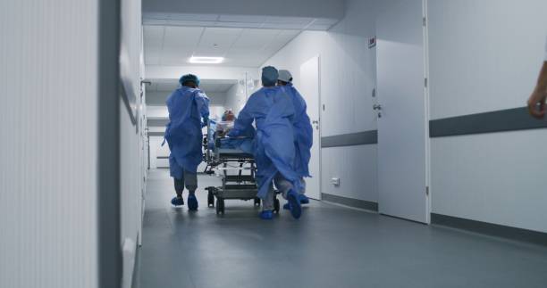 istock Doctors push stretcher with injured patient 1717840494