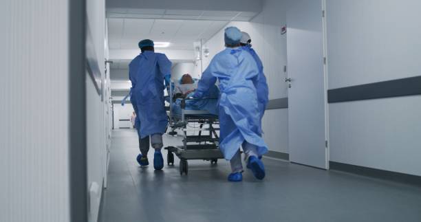 istock Doctors push stretcher with injured patient 1717840622