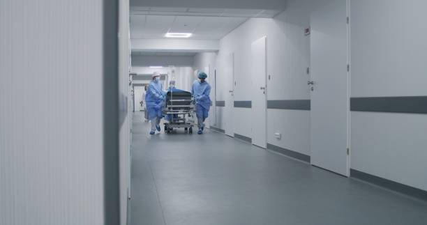 istock Doctors push stretcher with man to surgery room 1717840747