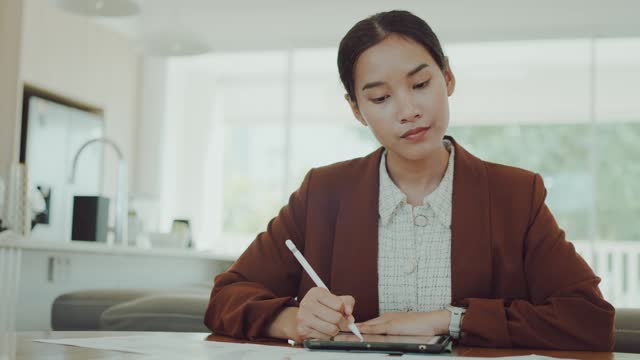 Young adult Asian woman hybrid working from home