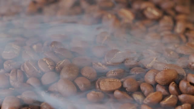 Roasted coffee beans with smoke.