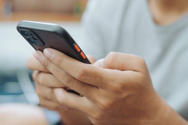 istock Hands of Asian man holding checking touching scrolling smartphone from bed room 1717866746