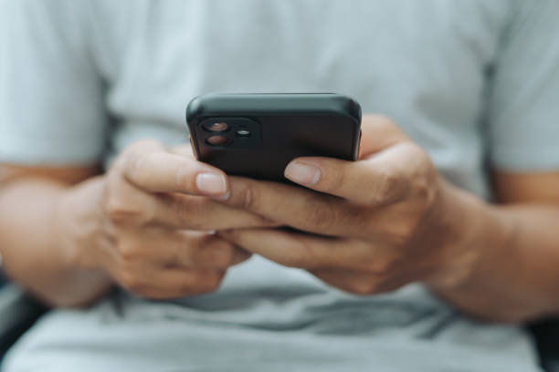 istock Hands of Asian man holding checking touching scrolling smartphone from bed room 1717871527