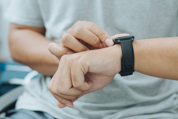 istock Asian man finger hand pressing smart watch buttons and screen 1717871532