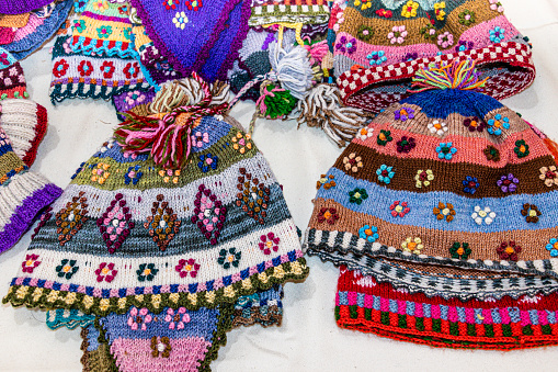 Handcraft souvenirs from Peru: colorful woolen knitted hats with tradition design of Cusco style at the Indian market in Lima