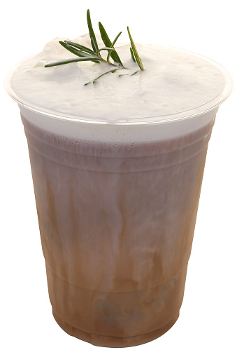 Iced cappuccino decorated with a sprig of rosemary and peach on top