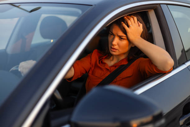 istock Nervous female driver sits at wheel, has worried expression as afraid to drive car by herself for first time. Frightened woman has car accident on road. People, driving, problems with transport 1717954893