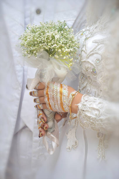 istock bride's hand holding a flower bouquet 1717980073