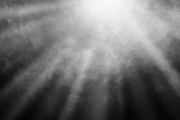 istock White and gray smoke against black background with light beams 1717990677