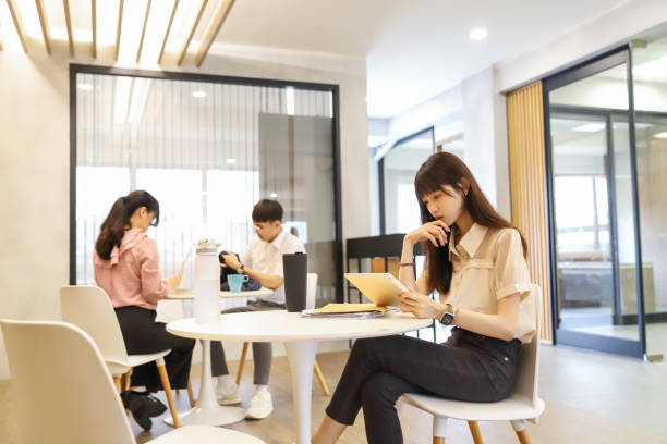 istock an Asian female office workers use tablets to relax in the tea room. 1718007708