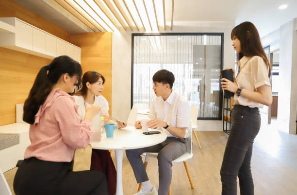 istock Female supervisor and employee discussing official matters using tablet 1718008217