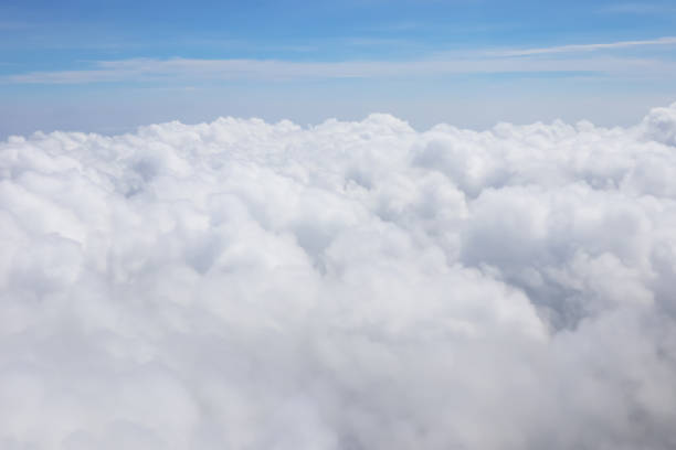 istock Aerial view of massive clouds and beautiful summer blue sky from aircraft window.Image use for environment and meteorology presentation background. 1718009238