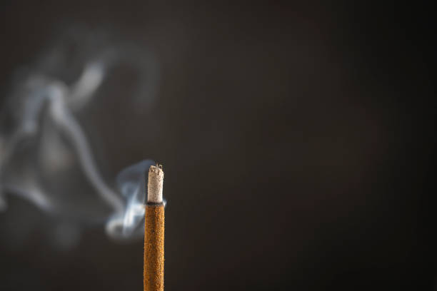 istock Asian incense stick burning with smoke, close up, macro 1718035682