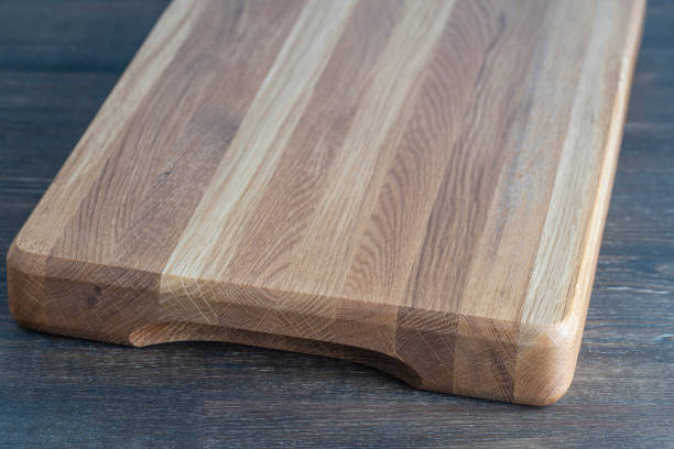 istock Wooden cutting board on wooden table background 1718036788