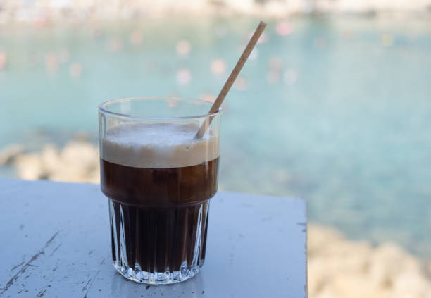 istock Fredo espresso iced coffee on the beach. Refreshment outdoor. Black coffee 1718065055
