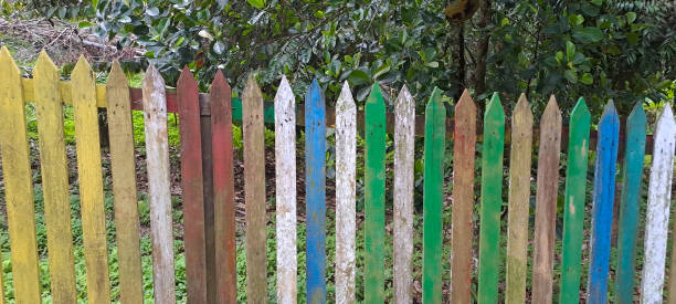 istock Multi colored rainbow wooden fence in garden background 1718073615