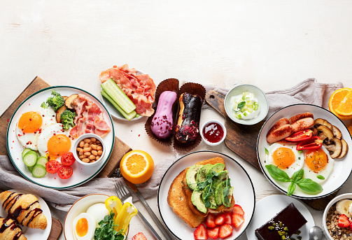 Healthy breakfast eating concept, various morning food on light background. Top view. Copy space.