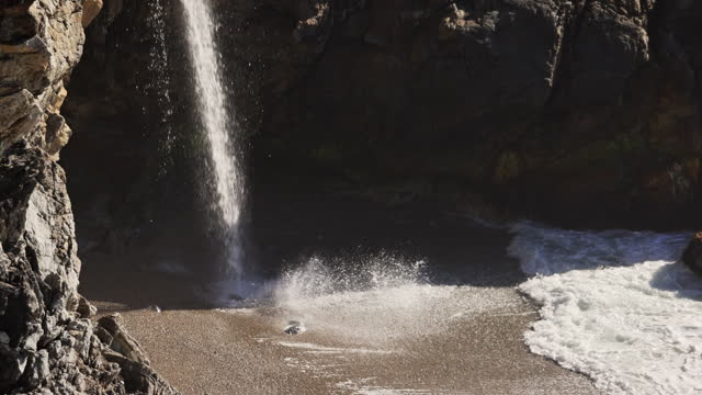 Close up of McWay falls waterfall on the beach at Julia Pfeiffer Burns state park