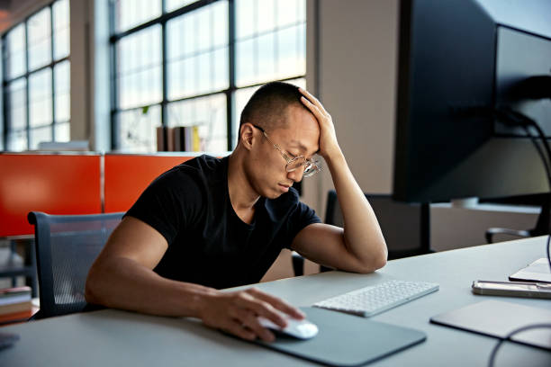istock Young Asian office worker falling asleep from boredom 1718111872