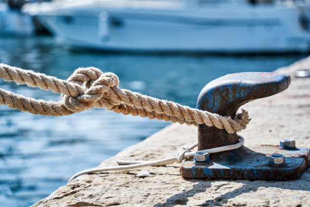 istock Thick rope securely fastened to a berth on the pier, concept for secure cohesion 1718118642