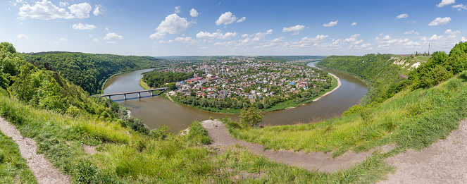 Scenic river loop of the Dniester river, flowing in the canyon valley near the town of Zalischyky, Ukraine. Panoramic view in summer day.