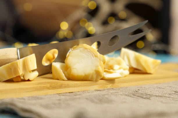 istock Man cutting cheese close-up, selective focus, cheese food preparing concept 1718184635