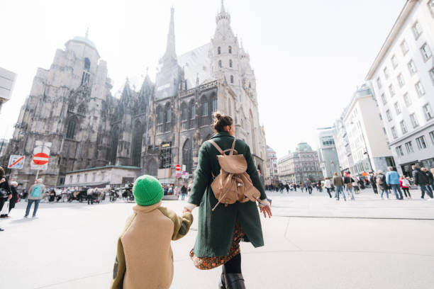 Young boy exploring the new city with his mother