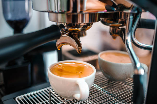 istock Coffee extraction from the coffee machine with a portafilter pouring coffee into a cup,Espresso pouring from the coffee machine at coffee shop 1718193493