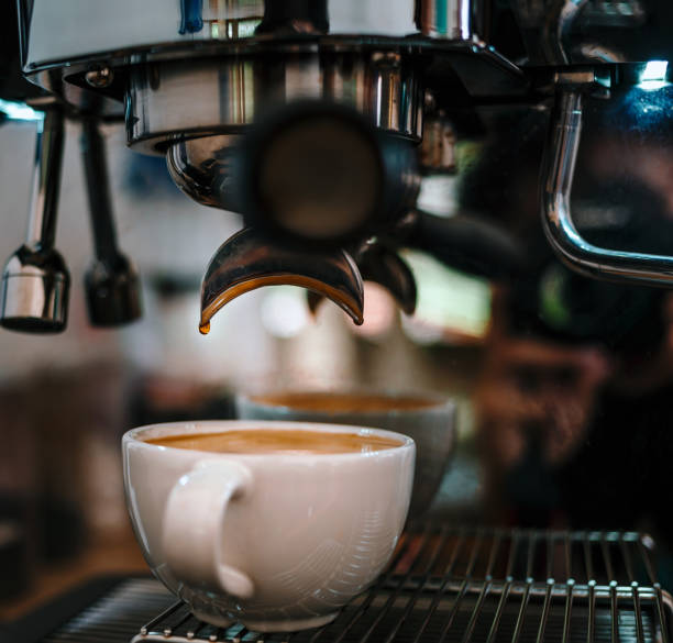 istock Coffee extraction from the coffee machine with a portafilter pouring coffee into a cup,Espresso pouring from the coffee machine at coffee shop 1718193519