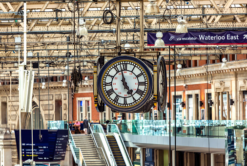 The vintage clock hanging in a London Station.