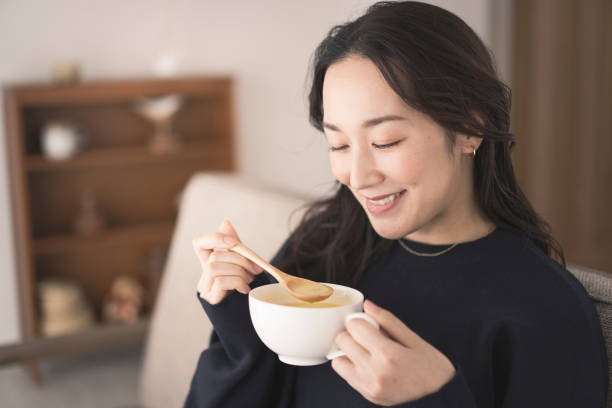 istock A woman is drinking hot soup. 1718228364