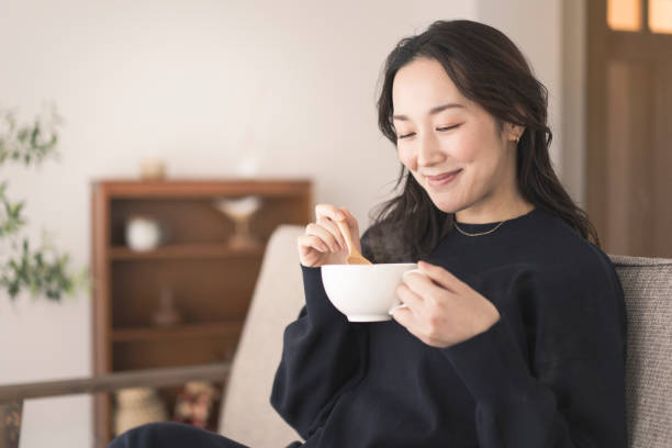 istock A woman is drinking hot soup. 1718228365