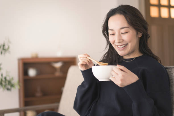 istock A woman is drinking hot soup. 1718228368