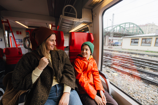Photo of a mother and son traveling by train across Europe