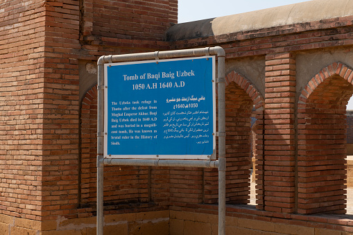 Sindh, Pakistan - February 04,2023: Beautiful mughal era carved sandstone tomb of Isa Khan Tarkhan II in UNESCO listed Makli necropolis, Thatta, Sindh, Pakistan