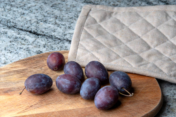 istock Hungarian plums on a cutting board 1718264264
